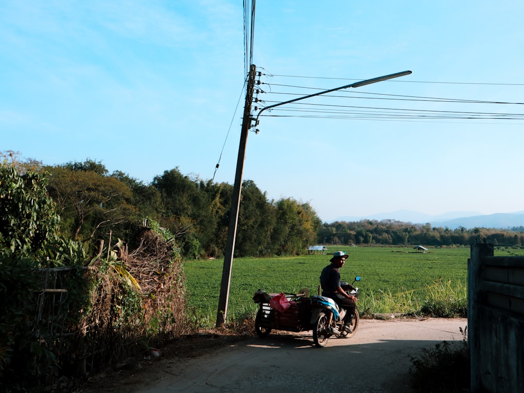 A man riding a motorcycle down a dirt road
